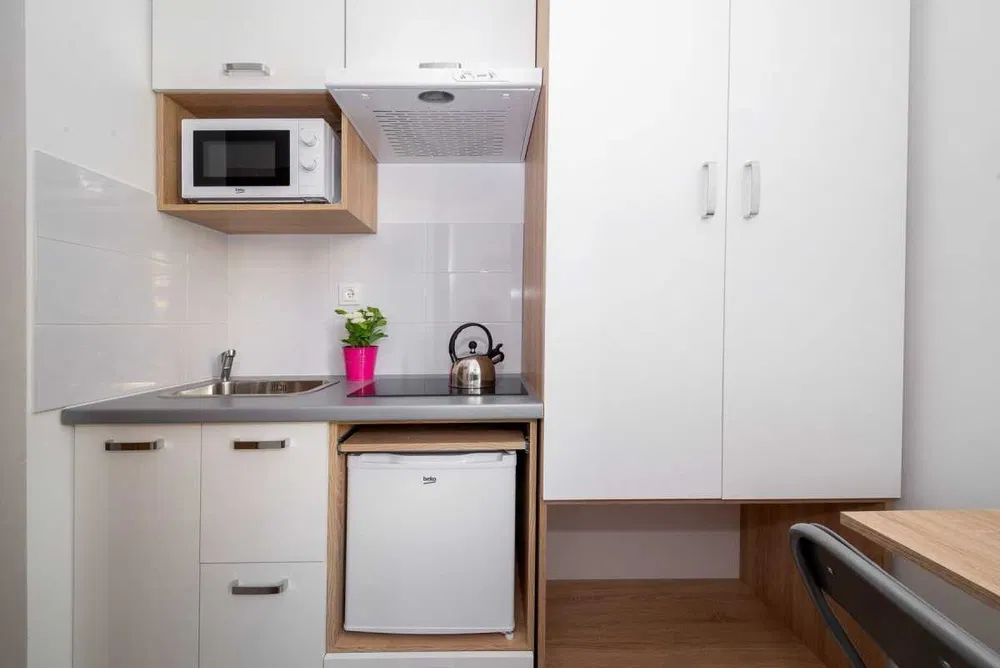 Budget-Friendly Studio at Jabłonna Street | Private Kitchen & Bathroom view